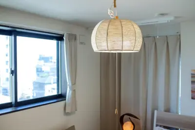 a light fixture in a room with a window at Tokyo Skytree 402 Bali-Style Double bed Bath & WC in Tokyo