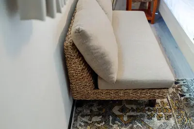 a couch sitting on a rug in a living room at Tokyo Skytree 402 Bali-Style Double bed Bath & WC in Tokyo