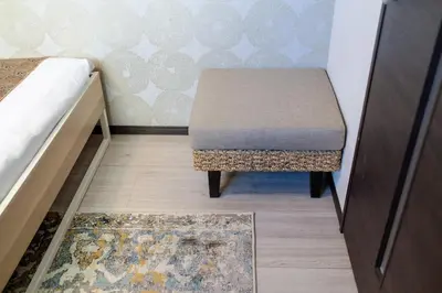 a small room with a stool and a rug at Tokyo Skytree 402 Bali-Style Double bed Bath & WC in Tokyo