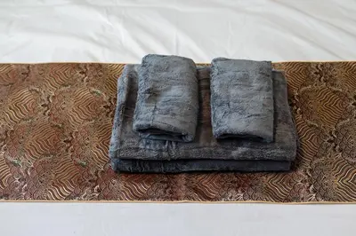 a tray with two towels on top at Tokyo Skytree 402 Bali-Style Double bed Bath & WC in Tokyo