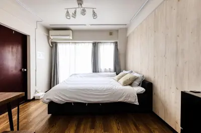 a bedroom with a large bed and a window at Shibuya Crossing 5mins walk COZY BRIGHT COMFY PAD 35sqm in Tokyo