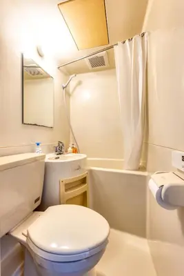 a white bathroom with a toilet and a tub and a sink at Shibuya Crossing 5mins walk COZY BRIGHT COMFY PAD 35sqm in Tokyo