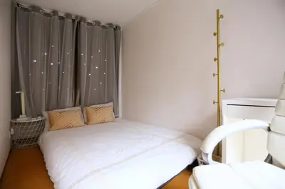 a small bedroom with a white bed and a window at \u99d2\u8fbc\u661f\u306e\u5bb6 Komagome in Tokyo