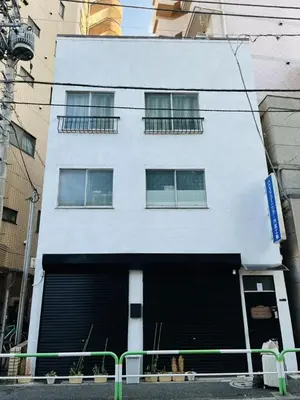 a large white building with a large garage at \u99d2\u8fbc\u661f\u306e\u5bb6 Komagome in Tokyo