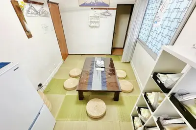 a small room with a table and two stools at \u99d2\u8fbc\u661f\u306e\u5bb6 Komagome in Tokyo