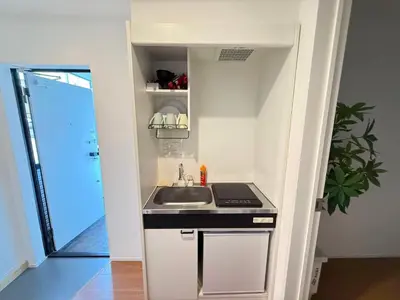 a small kitchen with a sink and a counter at Naomi\u4e2d\u91ce\u5742\u4e0a\u65b0\u5bbf-NN0126 in Tokyo
