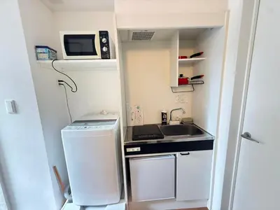 a small kitchen with a sink and a microwave at Naomi\u4e2d\u91ce\u5742\u4e0a\u65b0\u5bbf-NN0126 in Tokyo
