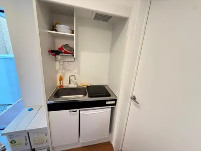 a small kitchen with a sink and a stove at Naomi\u4e2d\u91ce\u5742\u4e0a\u65b0\u5bbf-NN0126 in Tokyo