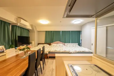 a bedroom with a bed and a table and chairs at \u76ee\u767d Yoko hotel shinnjuku, shinokubo 10 people stay, big room in Tokyo