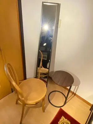 a room with a table and a chair and a mirror at The Hope Ikebukuro in Tokyo