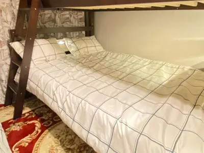 a bed with white comforter in a room at The Hope Ikebukuro in Tokyo
