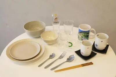 a white table with plates and utensils on it at Heureux\u690e\u540d\u753a301 in Tokyo