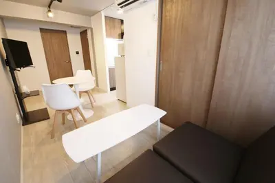 a living room with a white bench and a table at Heureux\u690e\u540d\u753a301 in Tokyo