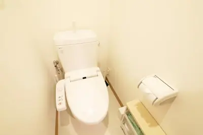a bathroom with a toilet and a roll of toilet paper at \u30ac\u30a4\u30a2\u6b4c\u821e\u4f0e\u753a203 in Tokyo