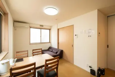 a living room with a table and a couch at Elle Maison\u5927\u68ee 102 in Tokyo