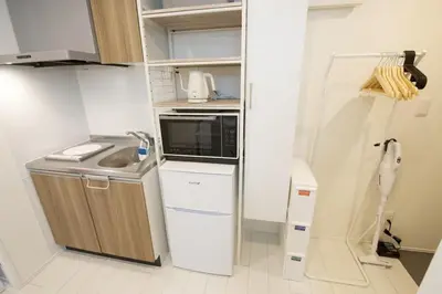 a small kitchen with a sink and a microwave at \u30aa\u30fc\u30d6\u30ea\u30aa\u30f3\u6075\u6bd4\u5bff202 in Tokyo