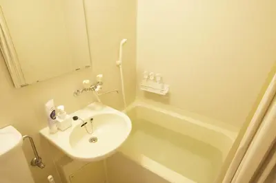 a bathroom with a sink and a toilet and a tub at \u30b5\u30f3\u30cf\u30a4\u30c4\u521d\u53f0401 in Tokyo