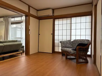 a living room with a couch and a chair at Kenichi Retreat in Tokyo