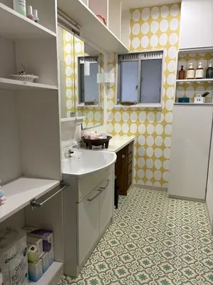 a kitchen with a white sink and a yellow wall at Kenichi Retreat in Tokyo