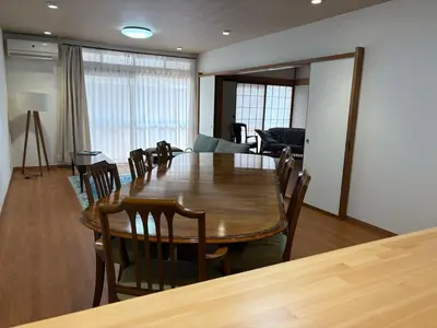 a dining room with a wooden table and chairs at Kenichi Retreat in Tokyo