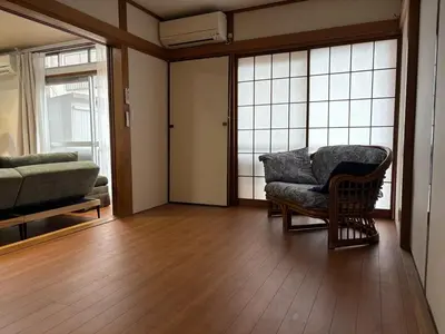 a living room with a couch and a chair at Kenichi Retreat in Tokyo