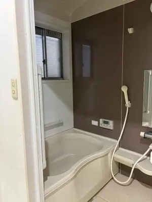 a bath tub in a bathroom with a window at Kenichi Retreat in Tokyo