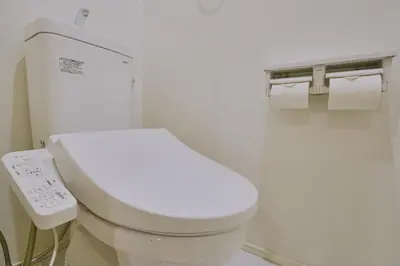 a bathroom with a white toilet with a remote control at Birthday House Skytree in Tokyo