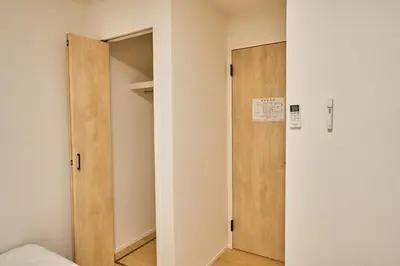 a room with a door and a closet at Birthday House Skytree in Tokyo