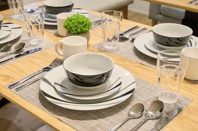 a wooden table with plates and bowls and spoons at Birthday House Skytree in Tokyo