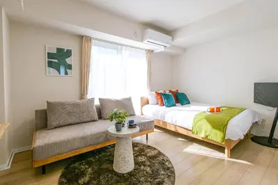 a living room with a bed and a couch at Mr Kintaro Hotel Kinshicho in Tokyo