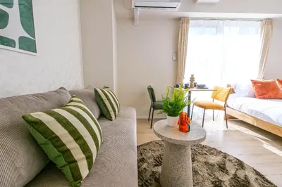 a living room with a couch and a bed at Mr Kintaro Hotel Kinshicho in Tokyo