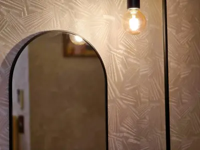 a mirror on a wall with a light on it at UENO 504 jellynehouse in Tokyo