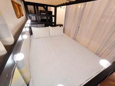 a small bed with white pillows in a room at UENO 504 jellynehouse in Tokyo