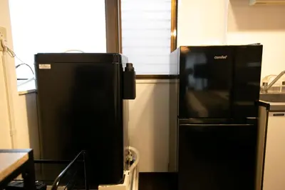 a refrigerator and a microwave in a kitchen at studio aoi 302 in Tokyo