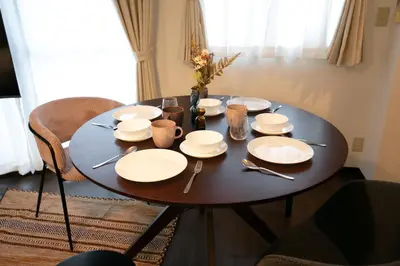 a table with white plates and utensils on it at studio aoi 302 in Tokyo