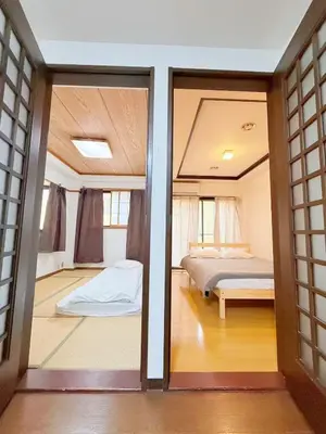 a view of a bedroom with a bed through a door at Shinjuku 2bed rooms sunny apart ment#2室1厅阳光公寓#高速无限制网路2&2 in Tokyo