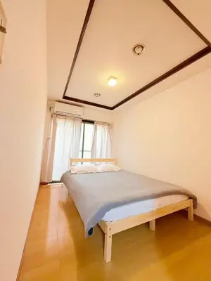 a bedroom with a bed in a room with a window at Shinjuku 2bed rooms sunny apart ment#2室1厅阳光公寓#高速无限制网路2&2 in Tokyo