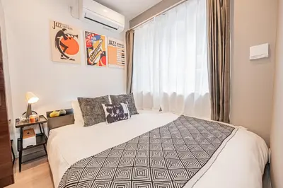 a bedroom with a bed and a window at Mi-HOTEL SHIMOKITAZAWA in Tokyo