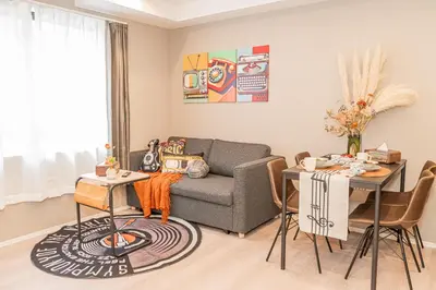a living room with a couch and a table at Mi-HOTEL SHIMOKITAZAWA in Tokyo