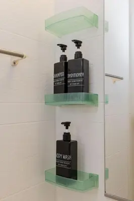 two bottles of soap on shelves in a bathroom at Tokyo Disneyland\u8eca20\u5206 Shinjuku Akihabara\u96fb\u8eca\u76f4\u901a\u306e\u5927\u6b63\u98a8\u8cb8\u5207\u4e00\u8ed2\u5bb6 in Tokyo