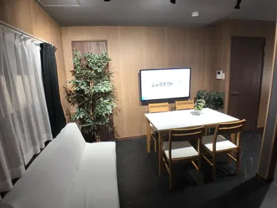 a conference room with a table and a tv at OZ nakano in Tokyo
