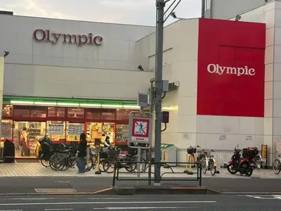 a woman walking past a store with bikes parked outside at OZ nakano in Tokyo