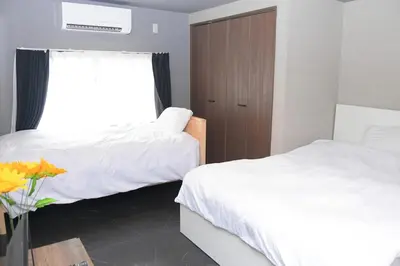 a hotel room with two beds and a window at OZ nakano in Tokyo
