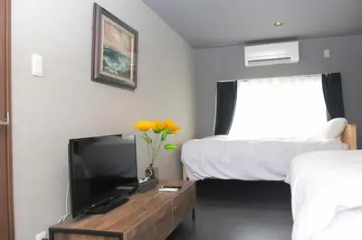 a hotel room with a tv and a bed at OZ nakano in Tokyo