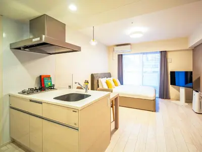 a kitchen with a sink and a bed in a room at Section L Residence Moto-Azabu in Tokyo