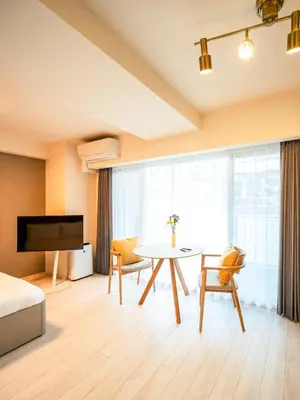 a hotel room with a table and a bed at Section L Residence Moto-Azabu in Tokyo