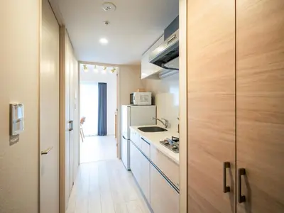 a small kitchen with a sink and a stove at Section L Residence Moto-Azabu in Tokyo