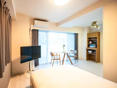 a bedroom with a bed and a table with chairs at Section L Residence Moto-Azabu in Tokyo