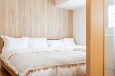 a bedroom with a large bed with white pillows at Ayame Building in Tokyo