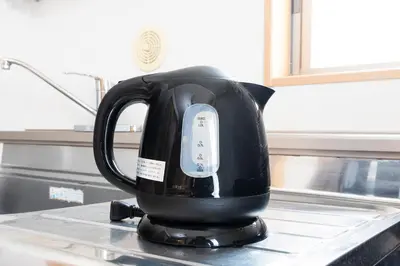 a black tea kettle sitting on top of a counter at Ayame Building in Tokyo